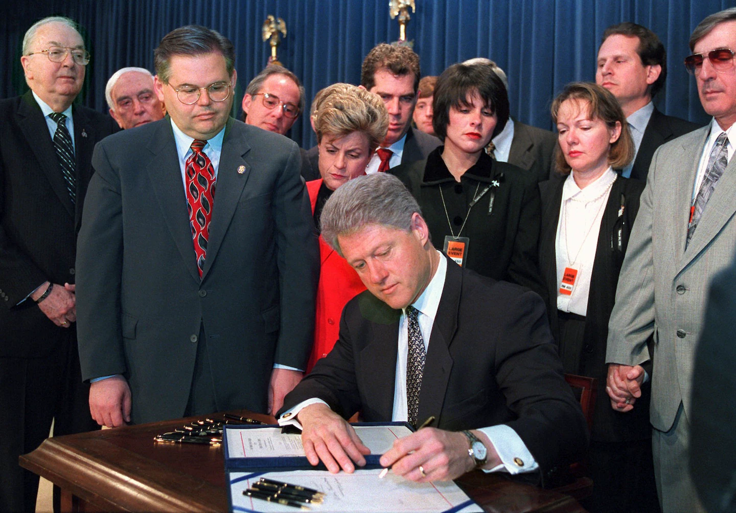 A photograph of President Bill Clinton signing the Helms-Burton Act